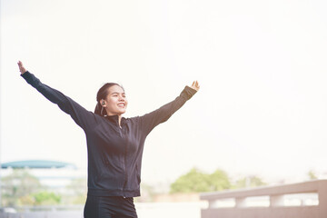 Young Asain woman with sportwear looking relaxing at outdoor. People relax and freedom style. Success of life concept.