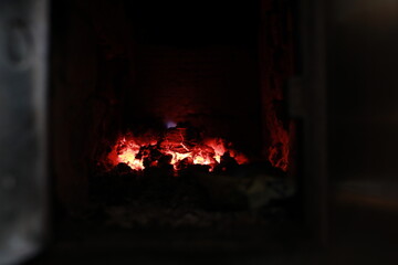heated stove in the house with red coals and fire