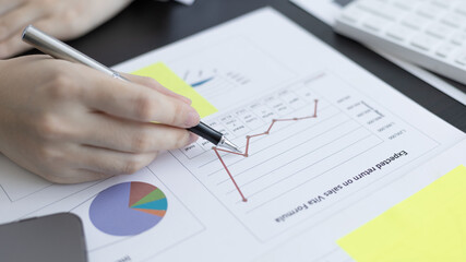 Asian business women are analyzing graphs, financial statistics and calculating corporate returns in private offices, Market research reports and income statistics, Financial and Accounting concept.