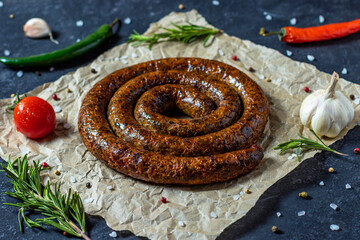 Oktoberfest snack BBQ spiral sausage with vegetables.