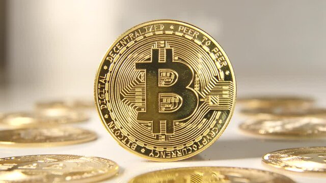 Golden bitcoin brightens up under shiny light.