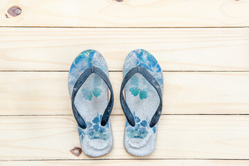 A pair of sandals on a plank.