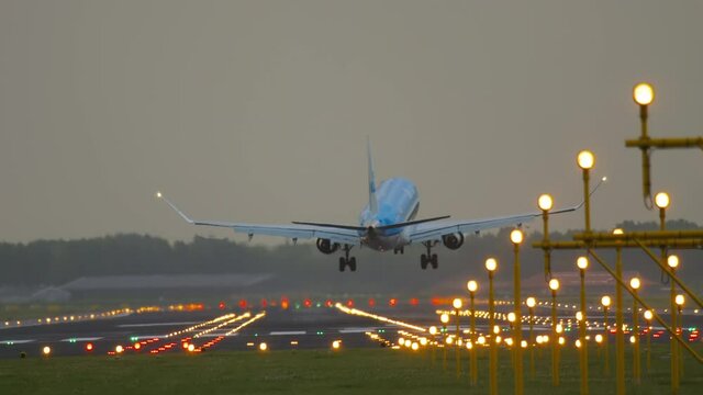 Airplane landing in the background of landing lights