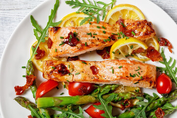 grilled salmon fillets with lemon, bacon,vegetables