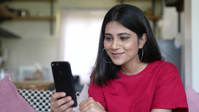 Beautiful Asian Woman making a video call smiling and talking with her friend and family.Businesswoman having video call discussing,working online meeting with team at home office.social distance.