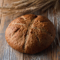 Close up of textured sourdough organic bread with spikes aside, country-style photo for commercial