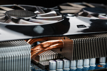Video card with a cooling system with copper pipes, aluminum radiators and fans.