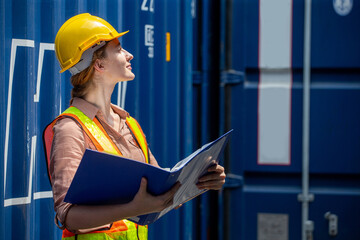 Containers woman worker using Folders file to inspection Containers box . female foreman Check inventory by Documents at warehouse logistic in Cargo freight ship for import export. shipping