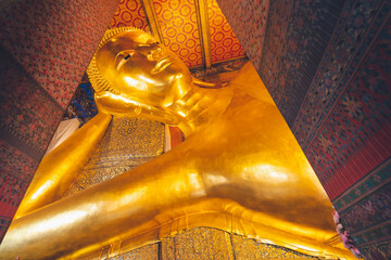 the image of gold reclining Buddha in capital palace wat pho temple bangkok thailand