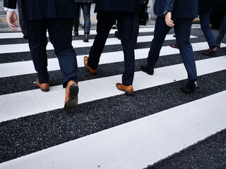 Businessmen legs in dark suit on a street crossing