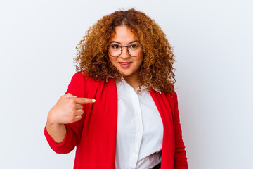 Fototapeta premium Young latin curvy woman isolated on white background person pointing by hand to a shirt copy space, proud and confident