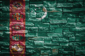 National flag of Turkmenistan  on stone  wall background.The concept of national pride and symbol...
