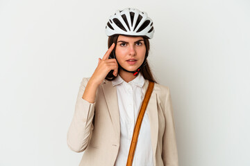 Young caucasian woman riding a bicycle to work isolated on white background pointing temple with finger, thinking, focused on a task.