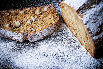 A close up of a loaf of banana bread with surrounding sugar.