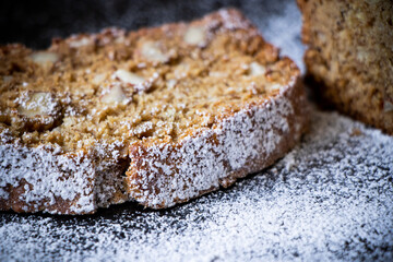 A close up of a loaf of banana bread with surrounding sugar.