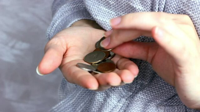 Caucasian woman hands holding and counting usa coin cents. Unemployment, poverty, savings and budget concept