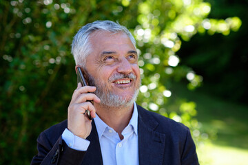 Happy businessman talking on the phone