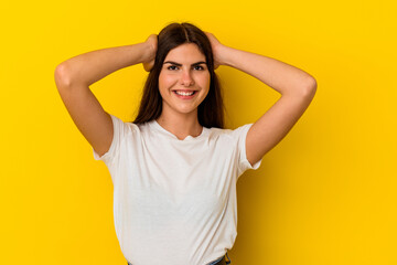 Young caucasian woman isolated on yellow background screaming, very excited, passionate, satisfied with something.