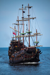 Old wooden pirate ship on the sea 