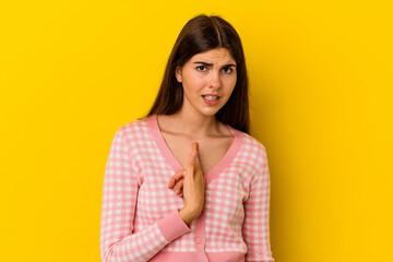 Fototapeta premium Young caucasian woman isolated on yellow background surprised pointing with finger, smiling broadly.