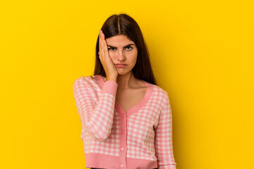 Fototapeta premium Young caucasian woman isolated on yellow background tired and very sleepy keeping hand on head.
