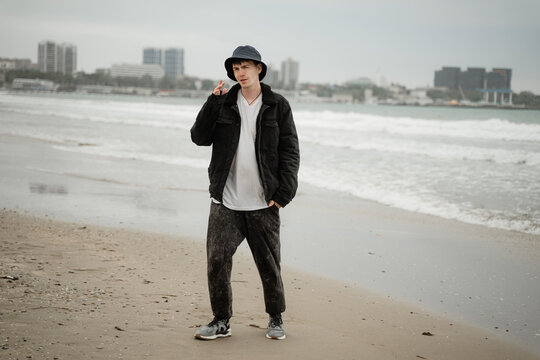 a young guy in Panama on the seashore indignantly shows a gesture