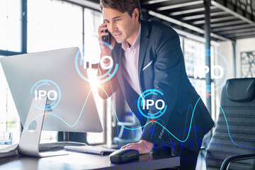Businessman in suit has conference call to optimize IPO strategy at corporate fund. Financial chart hologram over office background with panoramic windows