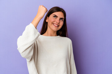 Fototapeta premium Young caucasian woman isolated on purple background celebrating a victory, passion and enthusiasm, happy expression.