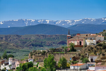 Fototapeta na wymiar View of the Palace of the Gallardo in Marchal (Granada - Spain) with Sierra Nevada in the background. It is a pink stately house known as 
