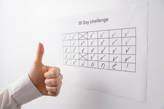 Cropped view of woman completing 30 days of challenge and showing thumb up