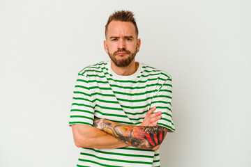 Fototapeta premium Young tattooed caucasian man isolated on white background blows cheeks, has tired expression. Facial expression concept.