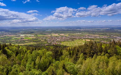 Fototapeta na wymiar View from Fremersberg to the town of Sinzheim with the Rhine valley near Baden Baden. In the background the Vosges. Baden Wuerttemberg, Germany