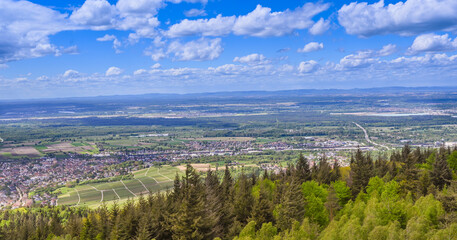Fototapeta na wymiar View from Fremersberg to the town of Sinzheim with the Rhine valley near Baden Baden. In the background the Vosges. Baden Wuerttemberg, Germany