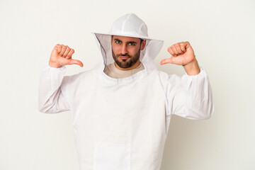 Young apiculture caucasian man isolated on white background feels proud and self confident, example to follow.