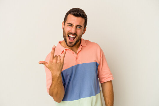 Young Caucasian Man Isolated On White Background Showing Rock Gesture With Fingers