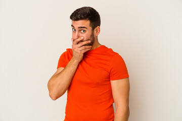 Young caucasian man isolated on white background scared and afraid.