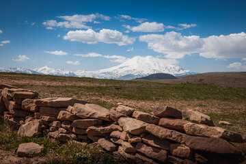 Elbrus And Green Hills with road At Sunny Summer Day. Dzhili-Su, Republic of Kabardino-Balkaria,North Caucasus, Russia.