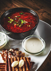 Beetroot soup Traditional Ukrainian or Russian borscht with sour cream in a bowl on wooden table