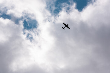 Airmanship. Aerobatics on an old Soviet plane from the Second World War in the sky with clouds and...