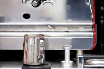 Mobile coffee shop. A fragment of a coffee machine with a metal pitcher and a coffee tempera....