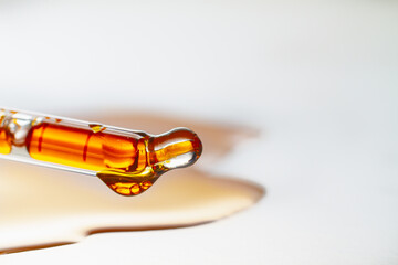 Cosmetic oil in a pipette, orange plant extract for beauty treatments