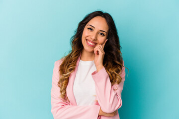 Young mexican woman isolated on blue background smiling happy and confident, touching chin with hand.
