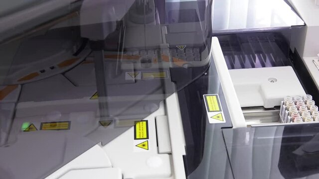 modern robotical machine for centrifuge blood and urine testing. Test Tube with blood sample for FSH, LH test. Sex Hormone test. A medical testing concept in the laboratory background.
