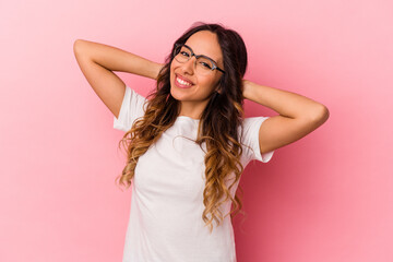 Young mexican woman isolated on pink background feeling confident, with hands behind the head.