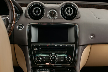 Luxury car interior. Multimedia screen and control buttons.
