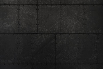 Close up detail of bolted black galvanised metal panel 