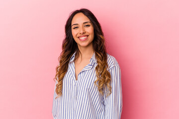 Fototapeta premium Young mexican woman isolated on pink background confident keeping hands on hips.