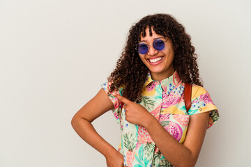 Young mixed race woman wearing sunglasses taking a vacation isolated smiling and pointing aside, showing something at blank space.