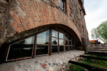 arched window of a 19th century mill with restoration in the village of Dvorishche