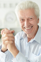 portrait of  senior man shaking hands  isolated on white background